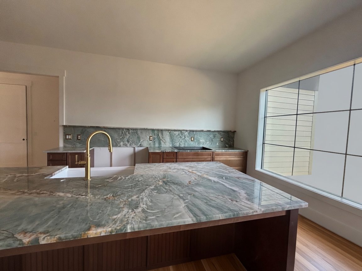 Green quartzite kitchen with full-height slab backsplash
